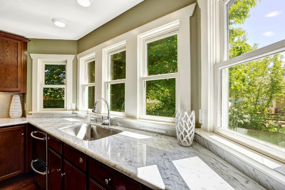 stone finished countertop with sink and cabinets